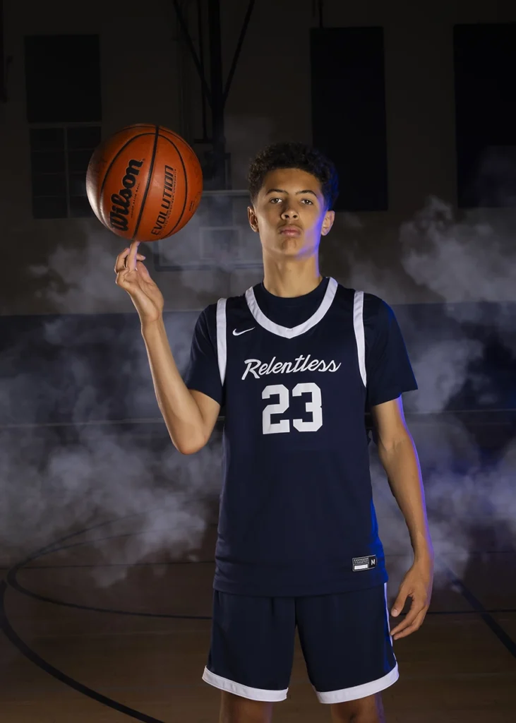 Sports Rock Media Photography: Basketball player spinning ball with one finger.