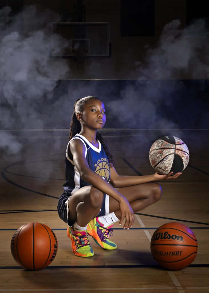 Sports Rock Media Photography: Young basketball player surrounded by many basketballs.