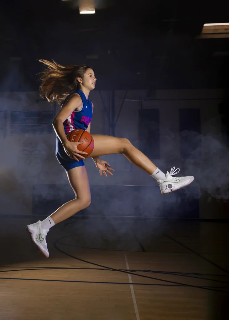 Sports Rock Media Photography: Basketball player showing her skills mid air.