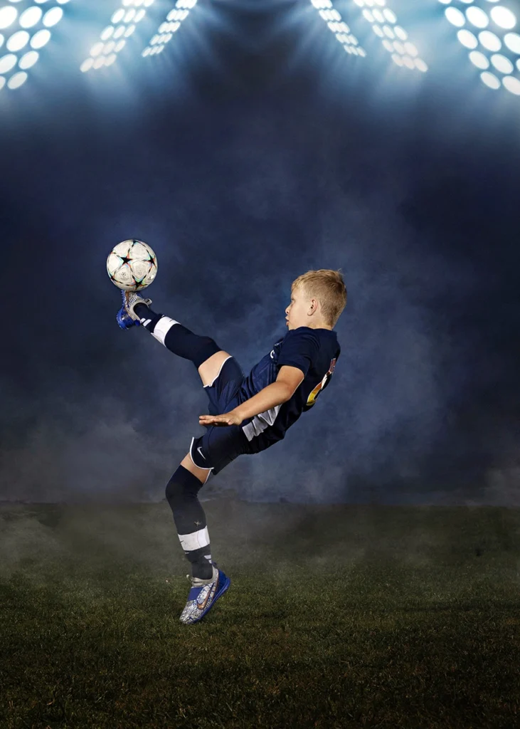 Sports Rock Media Photography: Young soccer player kicking the ball.