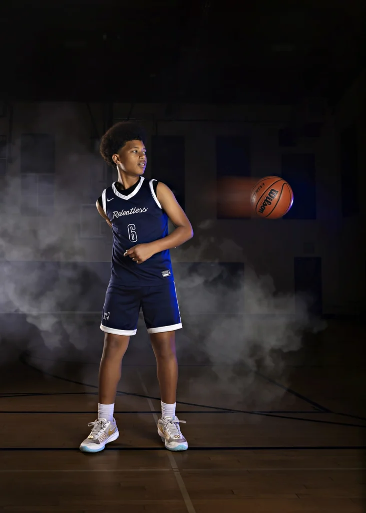 Sports Rock Media Photography: Basketball player passing ball behind his back.