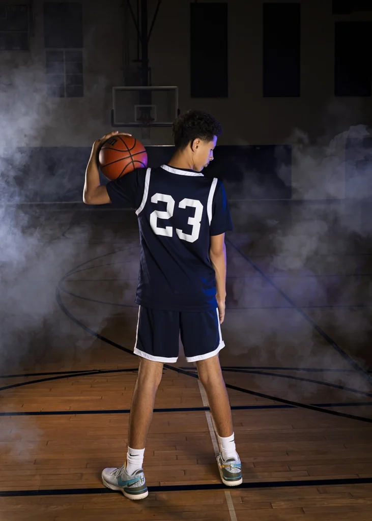 Sports Rock Media Photography: Basketball player showing his jersey number 23 while holding a ball.