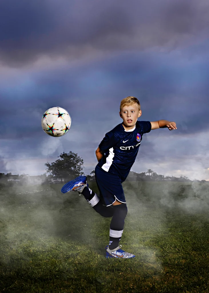 Sports Rock Media Photography: Young soccer player kicking the ball.